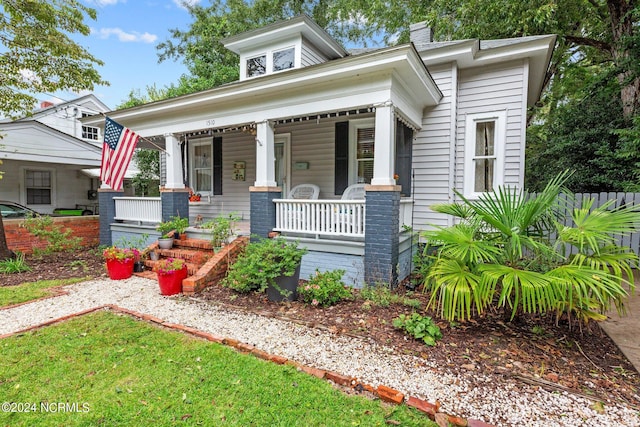 view of front of house featuring a porch and a chimney
