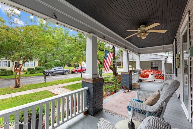 deck featuring a porch and ceiling fan