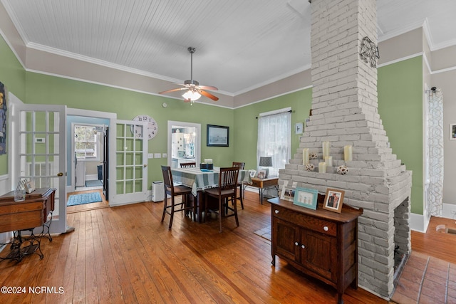 dining area with ceiling fan, ornamental molding, and wood-type flooring