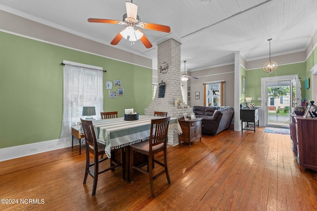 dining space with crown molding, baseboards, a ceiling fan, and hardwood / wood-style flooring