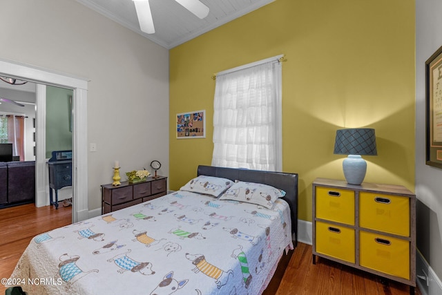 bedroom with ornamental molding, a ceiling fan, and wood finished floors