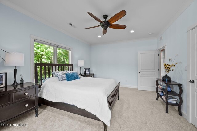 carpeted bedroom featuring ceiling fan and ornamental molding