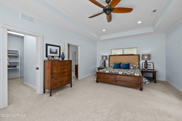 carpeted bedroom featuring recessed lighting, a raised ceiling, visible vents, and baseboards