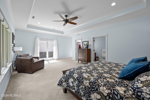 bedroom featuring carpet flooring, a raised ceiling, access to outside, ceiling fan, and connected bathroom