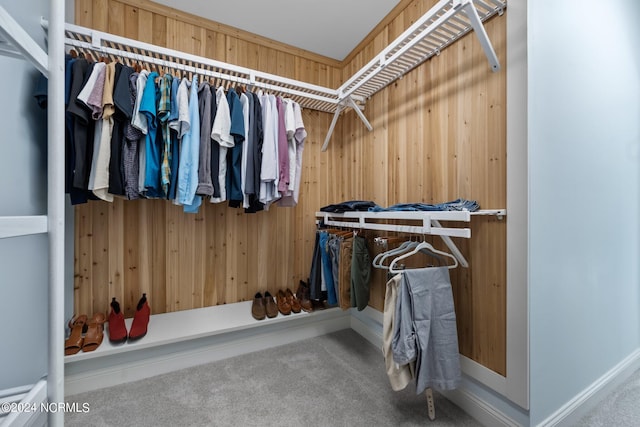 walk in closet with carpet