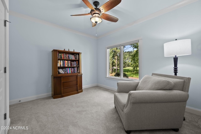 sitting room featuring crown molding, ceiling fan, and light carpet