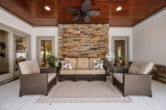 living room featuring ceiling fan and wooden ceiling