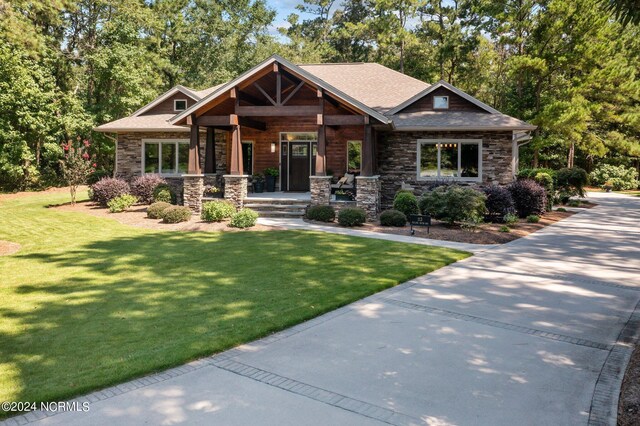 craftsman inspired home with covered porch and a front yard