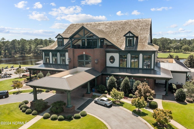 view of front of property with a front yard and a water view