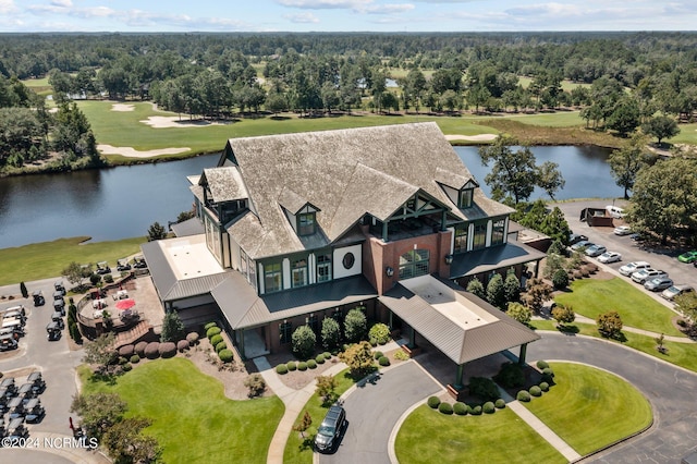 drone / aerial view featuring a water view and a view of trees