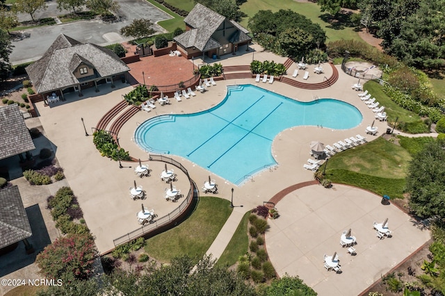 community pool featuring a patio and fence