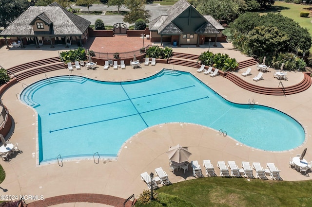 community pool featuring fence and a patio