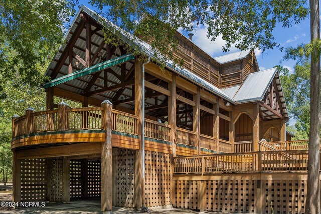 view of property exterior featuring a wooden deck