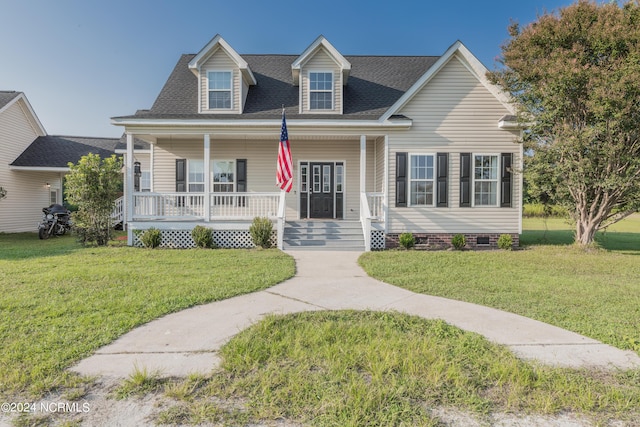 view of front of home with covered porch, a shingled roof, a front lawn, and crawl space