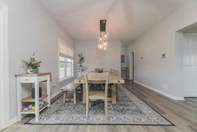 dining space with hardwood / wood-style flooring