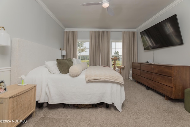 carpeted bedroom featuring a ceiling fan and crown molding