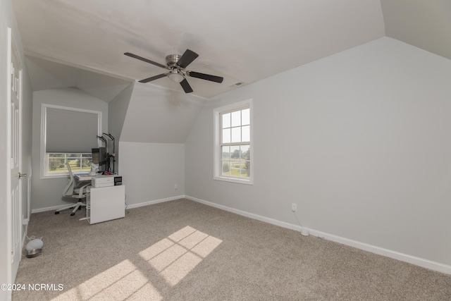 interior space featuring light carpet, vaulted ceiling, and ceiling fan