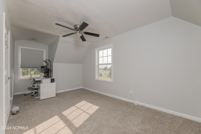 additional living space with lofted ceiling, light colored carpet, visible vents, a ceiling fan, and baseboards