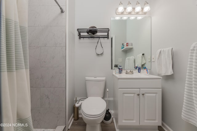 bathroom with walk in shower, vanity, toilet, and hardwood / wood-style flooring