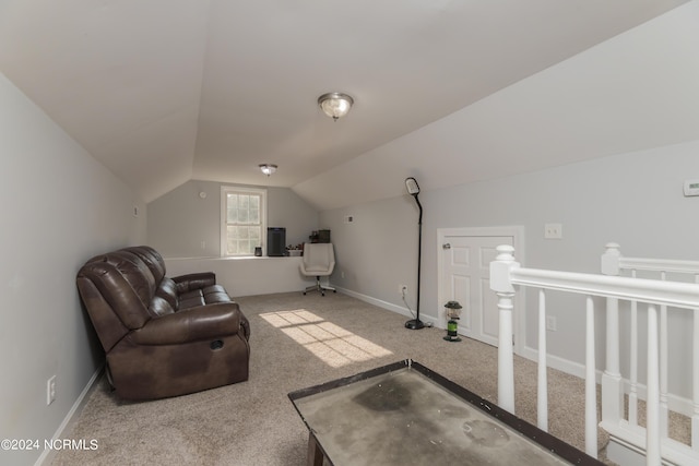 sitting room featuring vaulted ceiling, baseboards, and light colored carpet