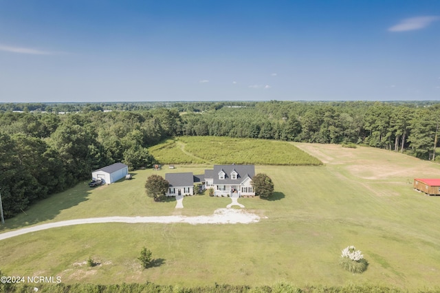 drone / aerial view featuring a rural view and a view of trees