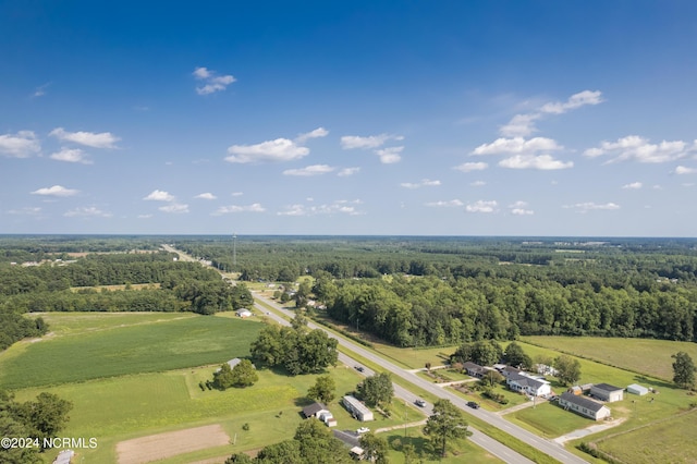 aerial view featuring a forest view and a rural view