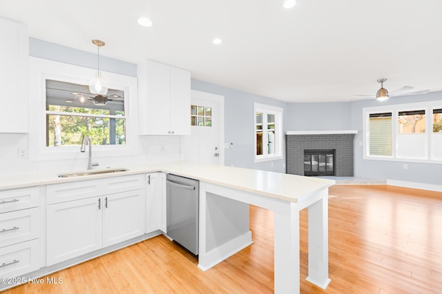 31 Augusta Dr, Oak Island, NC 28465 - kitchen featuring a sink, dishwasher, ceiling fan, decorative backsplash, and plenty of natural light
