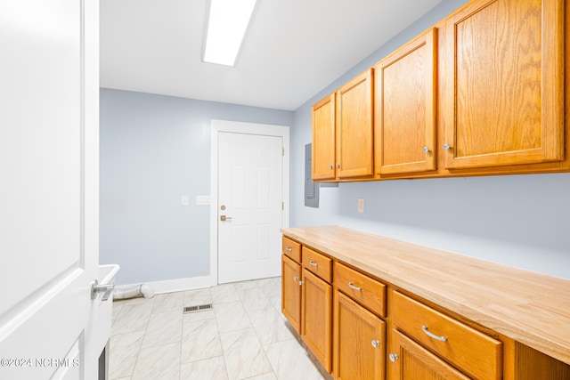31 Augusta Dr, Oak Island, NC 28465 - clothes washing area featuring baseboards, marble finish floor, and visible vents