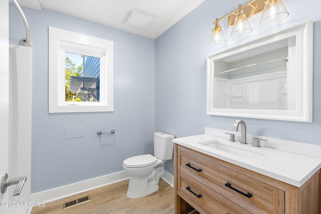 31 Augusta Dr, Oak Island, NC 28465 - full bath with baseboards, toilet, visible vents, vanity, and wood finished floors