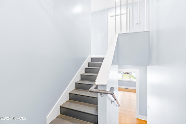31 Augusta Dr, Oak Island, NC 28465 - stairway with baseboards and wood finished floors