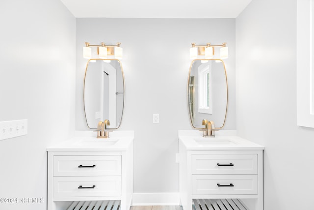 31 Augusta Dr, Oak Island, NC 28465 - bathroom featuring a sink, two vanities, and baseboards