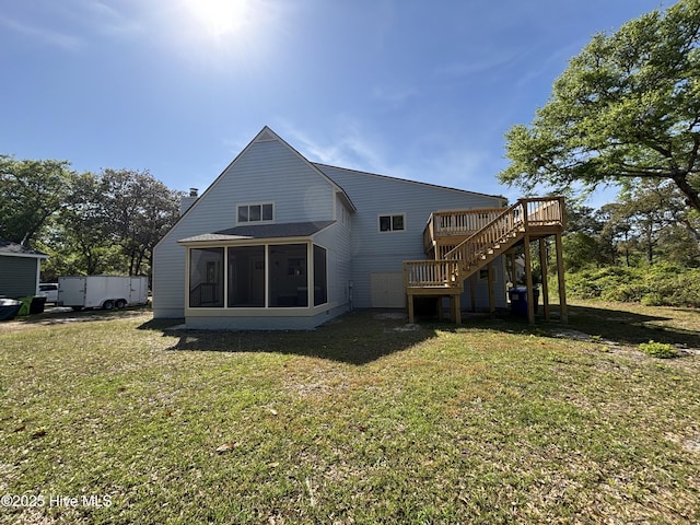 31 Augusta Dr, Oak Island, NC 28465 - back of property featuring a sunroom, a chimney, a deck, a yard, and stairs