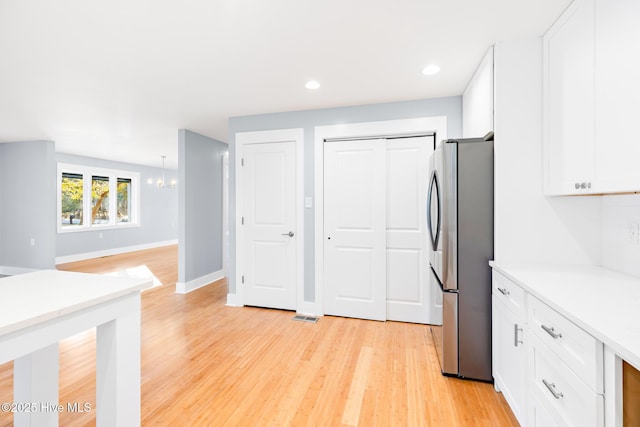 31 Augusta Dr, Oak Island, NC 28465 - kitchen featuring freestanding refrigerator, recessed lighting, light wood finished floors, light countertops, and white cabinets