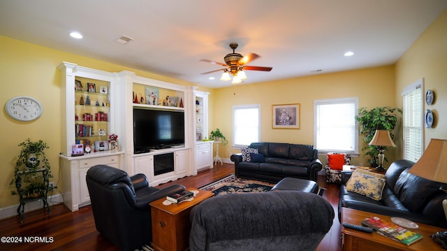 living area with baseboards, dark wood finished floors, and recessed lighting