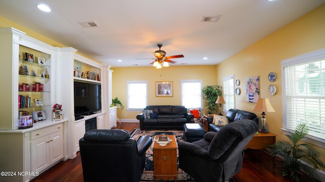 living room featuring dark wood-style floors, ceiling fan, visible vents, and recessed lighting