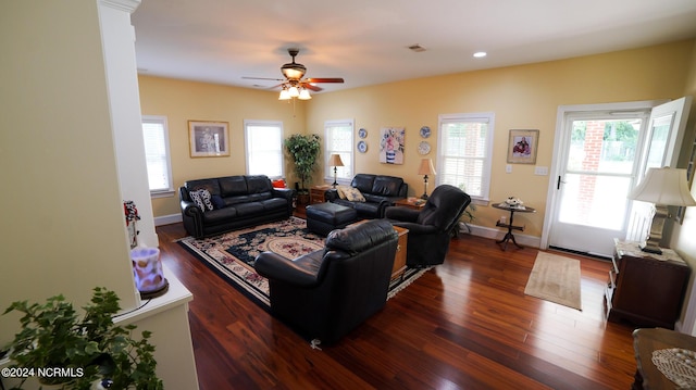 living room featuring dark wood-style flooring, recessed lighting, visible vents, and baseboards