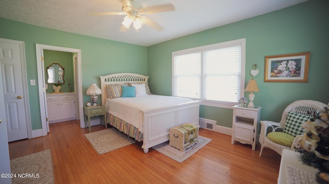 bedroom with visible vents, baseboards, ceiling fan, a textured ceiling, and light wood-style floors