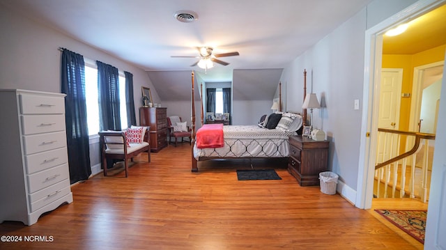 bedroom featuring baseboards, ceiling fan, visible vents, and light wood-style floors