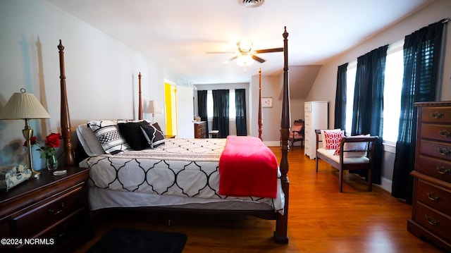 bedroom with visible vents, baseboards, and wood finished floors