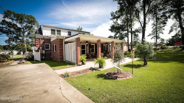 view of front of house featuring brick siding, a porch, and a front yard