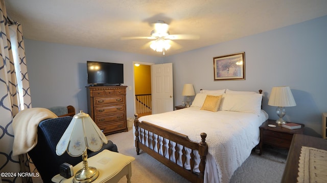 bedroom featuring light colored carpet and ceiling fan