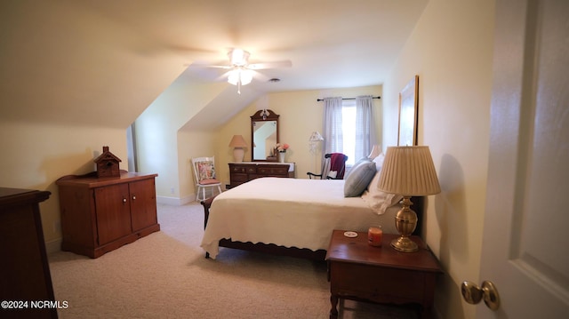 bedroom featuring lofted ceiling, light carpet, visible vents, a ceiling fan, and baseboards