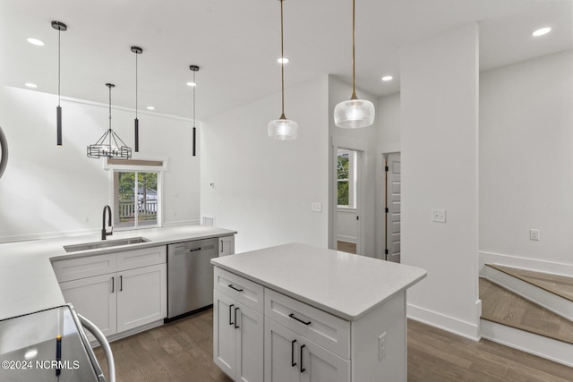 kitchen with sink, dishwasher, white cabinets, and hanging light fixtures