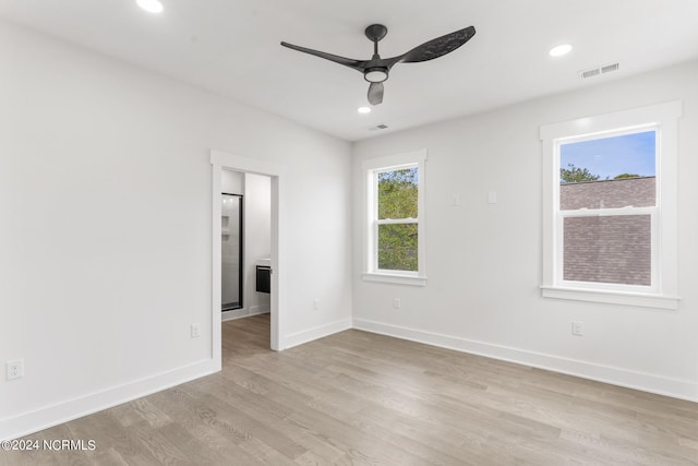 unfurnished room featuring light hardwood / wood-style flooring, a wealth of natural light, and ceiling fan