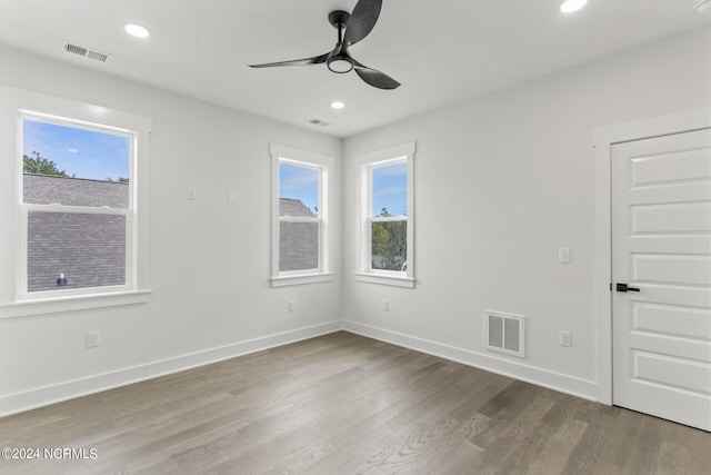 unfurnished room featuring hardwood / wood-style flooring, plenty of natural light, and ceiling fan