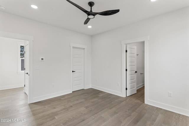 spare room with light hardwood / wood-style floors and ceiling fan