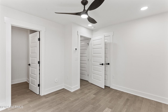 unfurnished bedroom featuring a closet, light hardwood / wood-style floors, and ceiling fan