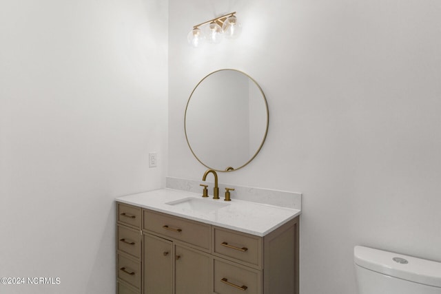 bathroom with toilet and vanity