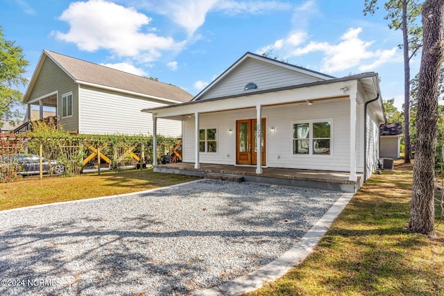 view of front of home with a porch and a front lawn