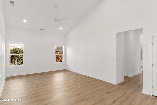 unfurnished room featuring light hardwood / wood-style floors, high vaulted ceiling, and ceiling fan